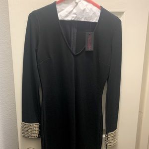 Black dress. Sequins cuffs. Front slit.